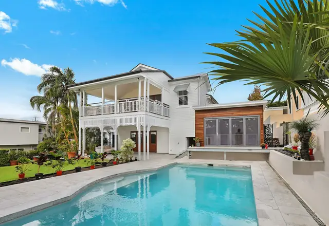Single-story home with palm trees and a pool